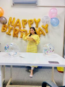 Wirsa Naseer smiling during her birthday celebration at Compilex Technologies.